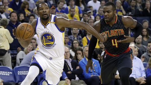 Golden State Warriors’ Kevin Durant (35) dribbles past Atlanta Hawks’ Paul Millsap (4) during the first half of an NBA basketball game, Monday, Nov. 28, 2016, in Oakland, Calif. (AP Photo/Marcio Jose Sanchez)