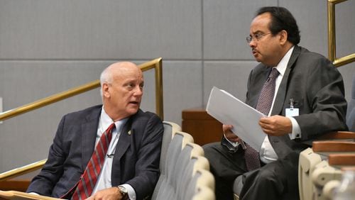 Michel 'Marty' Turpeau IV (right), chairman of DAFC, confers with State Senator Brandon Beach during a meeting at the Fulton County government building in Atlanta on Wednesday, July 14, 2021. (Hyosub Shin / Hyosub.Shin@ajc.com)