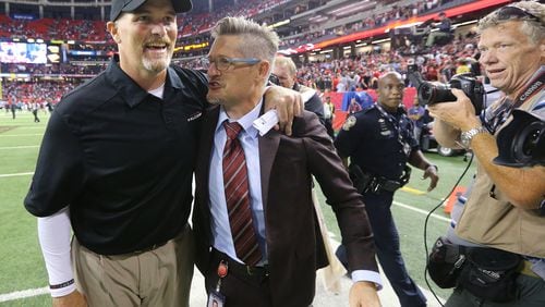 Dan Quinn and Thomas Dimitroff were all smiles after winning the season opener here and starting the season 5-0, but the Falcons slid from there and missed the playoffs. (Curtis Compton / ccompton@ajc.com)