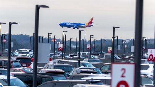 A Southwest Airlines plane lands near Terminal South parking at Hartsfield-Jackson Atlanta International Airport on Friday, December 22, 2023. (Steve Schaefer/steve.schaefer@ajc.com)