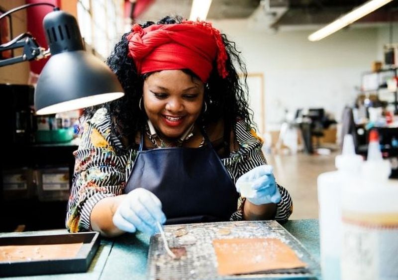 Azzie Caldwell and other Rebel Nell employees learn the art of jewelry making.  Fans have a piece of history.  Items that would otherwise be thrown away are put to good use.  And disadvantaged women are encouraged and empowered, says CEO Amy Peterson.  Courtesy of Rebel Nell