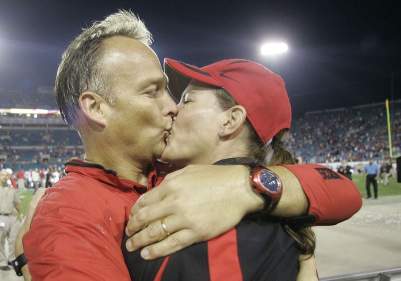 Georgia coach Mark Richt kisses his wife, Kathryn, after Georgia's 42-30 win over Florida. (AP Photo/Phil Coale)