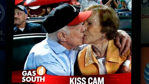 2015: Jimmy Carter kisses Rosalynn on the "Kiss Cam" during a baseball game between the Atlanta Braves and the Toronto Blue Jays in Atlanta. Carter had recently announced his cancer diagnosis. (John Bazemore / AP)