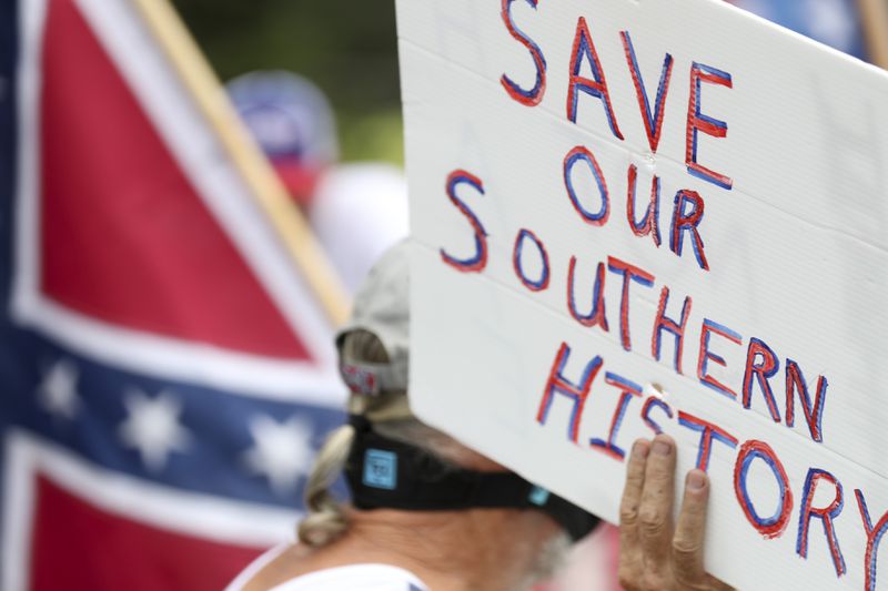 A sign at the Aug. 15 protest in Stone Mountain. (Alyssa Pointer / alyssa.pointer@ajc.com)