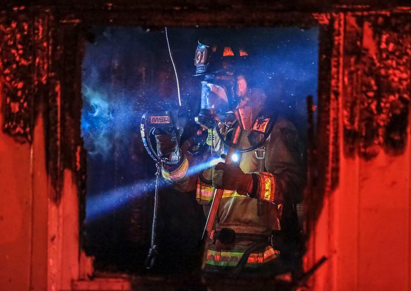 Atlanta firefighters worked the interior of a house fire using thermal imaging cameras to hit hot spots of a pretty stubborn fire that ripped through a southwest Atlanta home early Monday leaving two adults and three children without a place to live. (JOHN SPINK/JSPINK@AJC.COM)