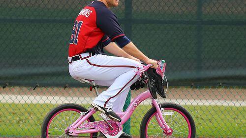 Braves pitching prospect Shae Simmons rides the bike B.J. Upton bought for him as good-natured "punishment" for Simmons catching a ride on a golf cart at a workout last week, a convenience reserved for veterans and staff. (Curtis Compton photo/AJC)