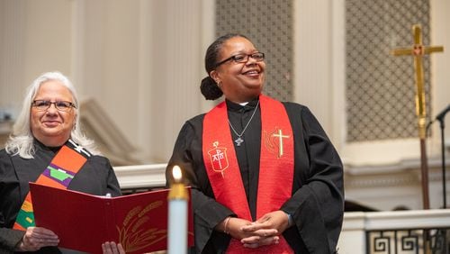 Rev. Dr. Nora Colmenares, left, supports Bishop Robin Dease, right, as Dease is installed as leader of the North Georgia Conference United Methodist Church on Sunday, Jan 8, 2023.  (Jenni Girtman for the Atlanta Journal-Constitution)