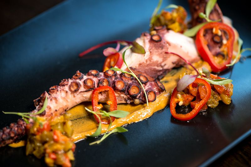 Octopus with spicy romesco and caper kachumber. Photo credit: Mia Yakel.