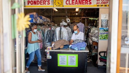 Ponder’s Cleaners owners Deborah Ponder (left) and her husband, Roderick Ponder, sort through clothing at their business in Atlanta on Saturday, June 13, 2020. (Photo: Branden Camp for The Atlanta Journal-Constitution)