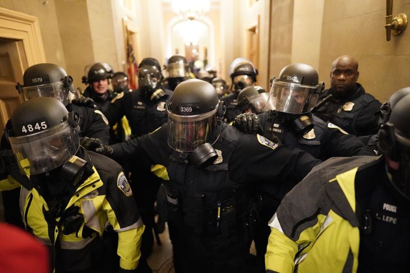 Riot police clear the hallway inside the Capitol on Jan. 6. (Kent Nishimura/Los Angeles Times/TNS)