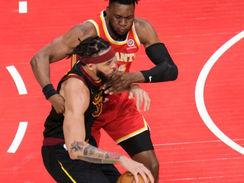 Atlanta Hawks forward Bruno Fernando (24) wraps up Cleveland Cavaliers center JaVale McGee (6) during the first half Sunday, March 14, 2021, at State Farm Arena in Atlanta. (Ben Gray/AP)
