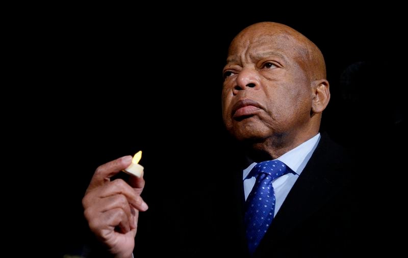 Congressman John Lewis of Georgia, who died in 2020, holds a candle during an event on Jan. 30, 2017, in front of the Supreme Court in Washington, D.C. (Olivier Douliery/Abaca Press/TNS)