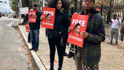 Spelman College student Eva Dickerson (right) and Atlanta resident Jill Cartwright (center) hold signs in support of a clemency push for Tennessee inmate Cyntoia Brown outside the Georgia Capitol on Saturday, Dec. 15, 2018, in downtown Atlanta. Legal activists are urging Tennessee Gov. Bill Haslam to grant Brown’s clemency petition in a case that’s gained international attention. J. SCOTT TRUBEY/STRUBEY@AJC.COM
