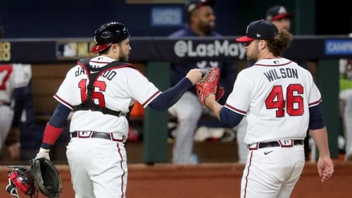 Braves starting pitcher Bryse Wilson gets a fist bump from catcher Travis d'Arnaud following the second inning of NLCS Game 4 on Thursday. (Curtis Compton / Curtis.Compton@ajc.com)