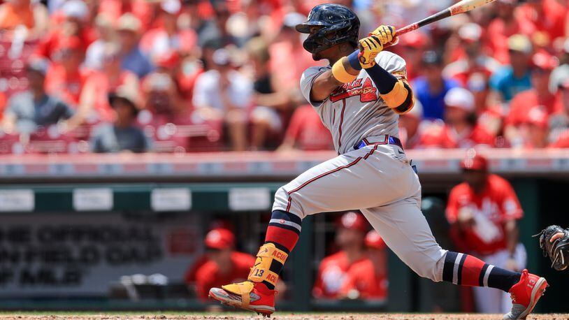 Braves outfielder Ronald Acuna hits an RBI-double during the third inning against the Cincinnati Reds Sunday, June 27, 2021, in Cincinnati. (Aaron Doster/AP)