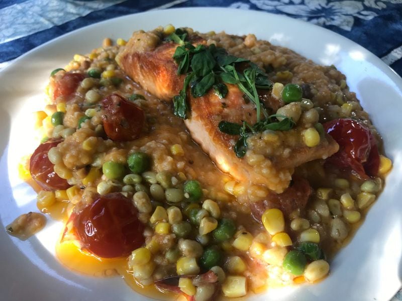 Bay of Fundy salmon is a menu staple at Drift. Accompaniments of smoked tomato grits and field pea and corn succotash make for a hearty entree. LIGAYA FIGUERAS / LIGAYA.FIGUERAS@AJC.COM
