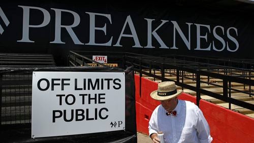 FILE - A spectator walks past a closed section of grandstands at Pimlico Race Course ahead of the Black Eyed Susan horse race, May 17, 2019, in Baltimore. The storied but decaying home of the second jewel of the Triple Crown, Pimlico Race Course, is finally on the verge of much-needed repairs. The Preakness on Saturday, May 18, 2024 will be the last before work begins, with the race in 2025 set to be run mid-construction before moving to Laurel Park in 2026 and returning. (AP Photo/Patrick Semansky, file)