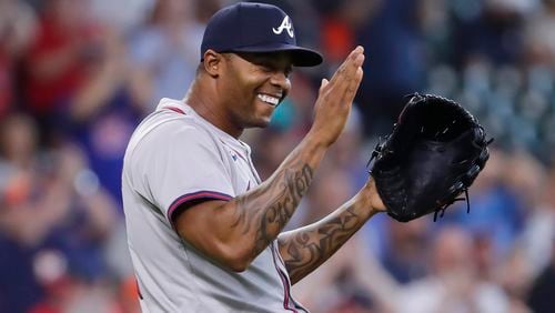Atlanta Braves closer pitcher Raisel Iglesias celebrates after a baseball game against the Houston Astros, Wednesday, April 17, 2024, in Houston. The Braves won 5-4 in 10 innings.  (AP Photo/Michael Wyke)