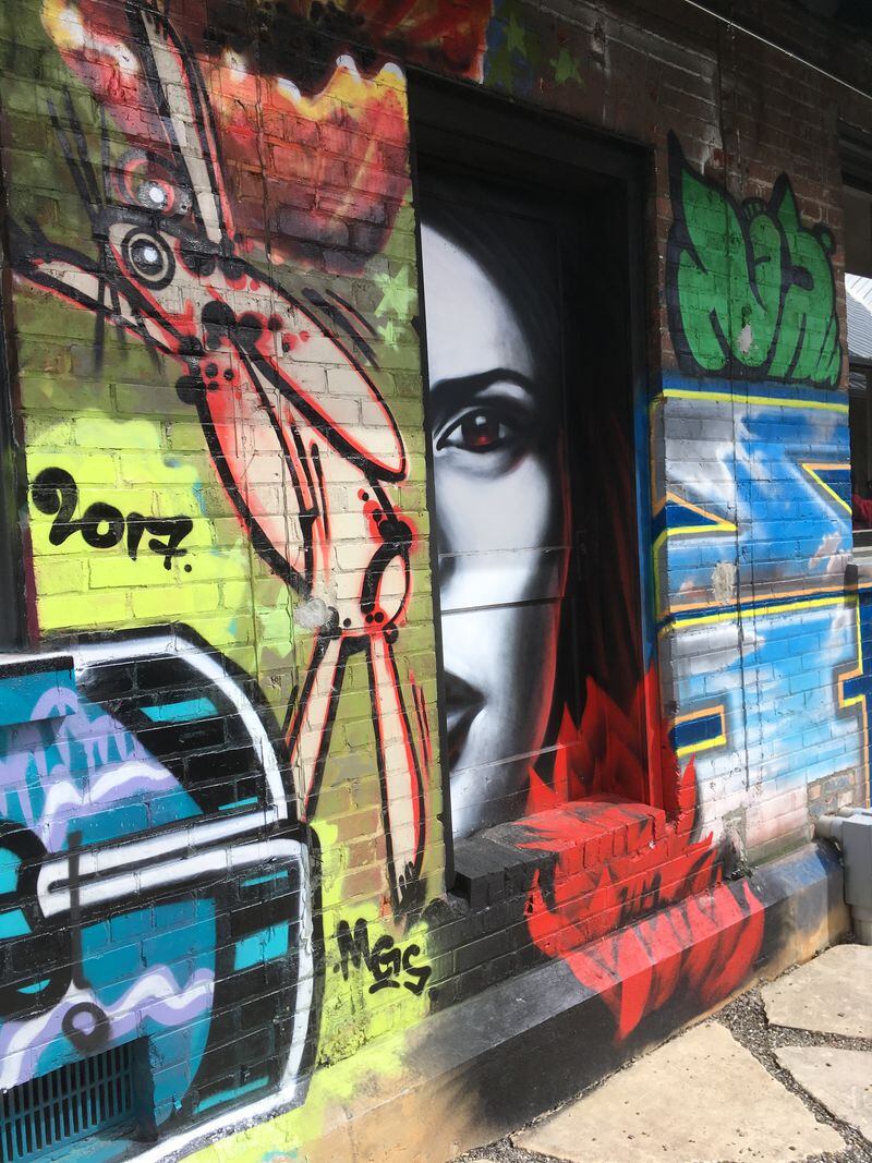  Graffiti decorates the walls of the Wedge Brewing and 12 Bones Smokehouse complex in Asheville's River Arts District. PHOTO CREDIT: Bob Townsend.