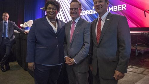Georgia gubernatorial candidates Stacey Abrams and Brian Kemp, right, stand Tuesday with Georgia Chamber of Commerce President and CEO Chris Clark following the group’s Congressional Luncheon at the Macon Marriott City Center. Both candidates used the forum to explain their plans for Georgia’s economy. (ALYSSA POINTER/ALYSSA.POINTER@AJC.COM)
