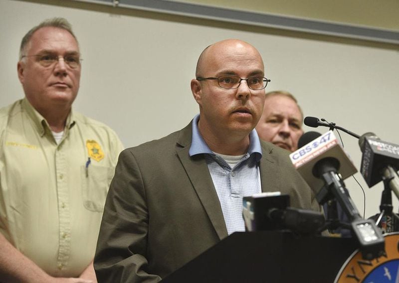 Glynn County Police Department chief of staff Brian Scott addresses members of the media while county Police Chief John Powell (left) and Glynn County Sheriff Neal Jump look on at a press conference about Robert C. Sasser on June 29, 2018, at the Glynn County Public Safety Complex. (BOBBY HAVEN / THE BRUNSWICK NEWS)