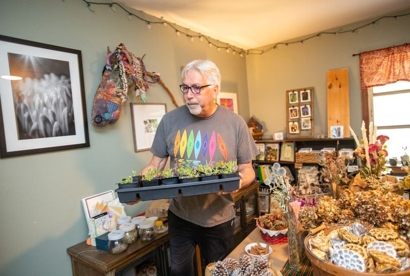 Photographer Matthew Berberich has printed hundreds of his photos of fthe garden's flowers and plants which he sells to raise money for the organization. (Jenni Girtman for Atlanta Journal-Constitution)