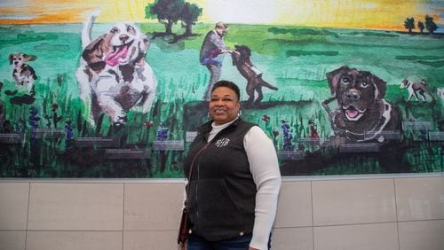 Portrait of Rita Harris who are featured, with her guide dog Madden, in the mural behind them in Course F at Hartsfield-Jackson International Airport. Harris is a blind women living in Madison who started a nonprofit to help others who are vision impaired. The organization is called Living Life Team.PHIL SKINNER FOR THE ATLANTA JOURNAL-CONSTITUTION.