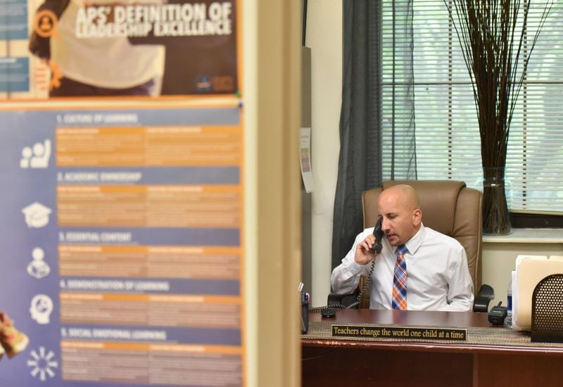 School Business Manager Brian Baron talks on the phone as he prepares before meeting with the principal Audrey Sofianos at his office at Elementary School on Friday, September 28, 2018. Baron was hired this school year to handle administrative duties so that the school principal could spend more time on instructional activities. HYOSUB SHIN / HSHIN@AJC.COM