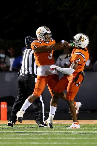 August 20, 2021 - Kennesaw, Ga: North Cobb quarterback Malachi Singleton (3) and wide receiver Marquis Groves-Killebrew (2) celebrate the touchdown catch from Singleton to Groves-Killebrew during the first half at North Cobb high school Friday, August 20, 2021 in Kennesaw, Ga.. JASON GETZ FOR THE ATLANTA JOURNAL-CONSTITUTION