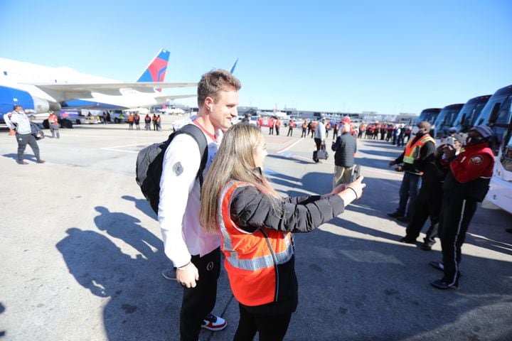 Delta Airlines worker Brittany Brownlee takes a selfie with a Georgia football player Ryland Goede as the team arrives at the Hartsfield-Jackson Atlanta International Airport on Tuesday, January 11, 2022. Miguel Martinez for The Atlanta Journal-Constitution