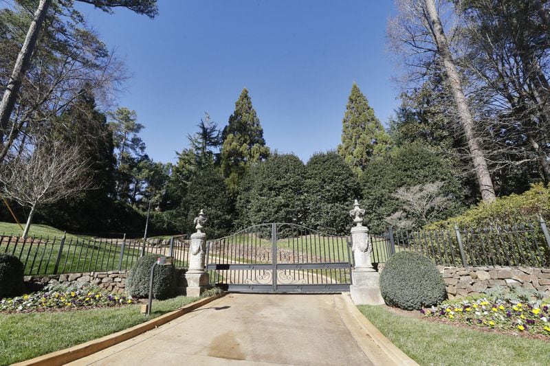 Kelly Loeffler’s Buckhead home is hidden by trees in this view of the front gate from the street. Loeffler is CEO of bitcoin trading company Bakkt and is an executive with Atlanta-based Intercontinental Exchange, the New York Stock Exchange parent company. BOB ANDRES / BANDRES@AJC.COM