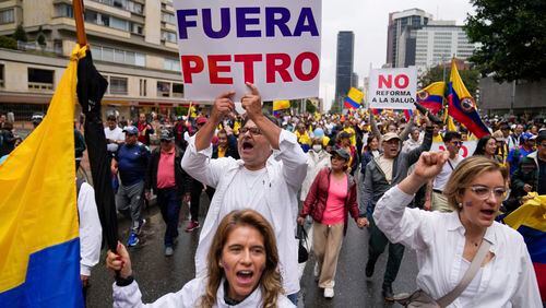 Anti-government demonstrators march to protest economic and social reforms pushed by the government of President Gustavo Petro and his proposal to convene a constituent assembly in Bogota, Colombia, Sunday, April 21, 2024. (AP Photo/Fernando Vergara)