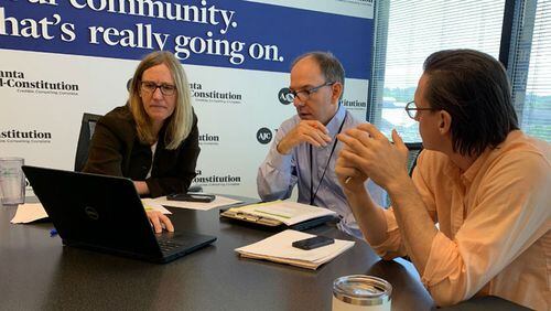 AJC investigative reporters Carrie Teegardin and Brad Schrade, center, meet with data specialist Nick Thieme to discuss the 'Unprotected' series.
