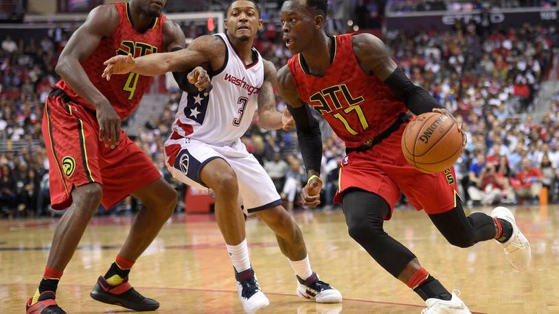 Atlanta Hawks guard Dennis Schroder, of Germany, (17) dribbles against Washington Wizards guard Bradley Beal (3) during the second half in Game 5 of a first-round NBA basketball playoff series, Wednesday, April 26, 2017, in Washington. Also seen is Atlanta Hawks forward Paul Millsap (4). The Wizards won 103-99. (AP Photo/Nick Wass)