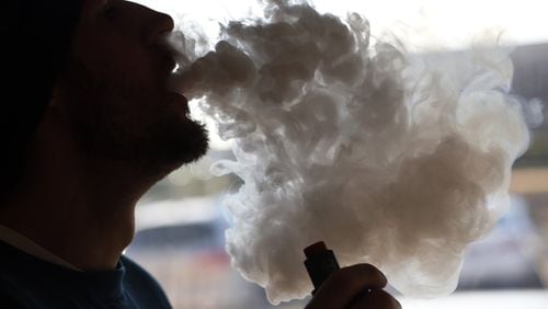 In this Friday, Jan. 18, 2019 file photo, a customer blows a cloud of smoke from a vape pipe at a local shop in Richmond, Va.