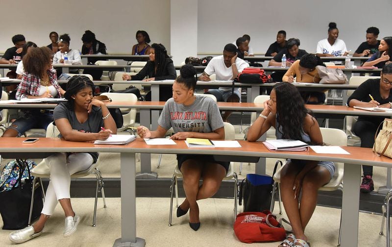 Kendall Youngblood, center, confers with classmates Abria Penu, left, and Asia Mone't Johnson-Clark, right, in an economics class at Clark Atlanta University on Tuesday, August 29, 2017. (HYOSUB SHIN / HSHIN@AJC.COM)