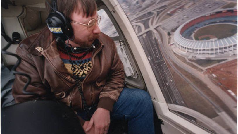 Traffic reporter, Herb Emory, from WSB Radio, giving a traffic report from a helicopter. Atlanta-Fulton County Stadium sits in the background, Atlanta, Georgia, January 3, 1994. AJC FILE PHOTO