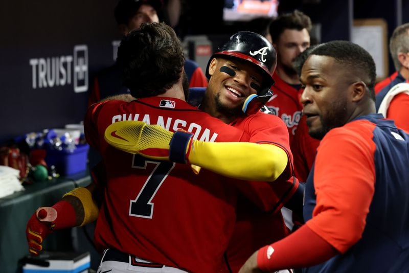 Braves right fielder Ronald Acuna, facing, and shortstop Dansby Swanson (7) celebrate their runs scored off of a double by second baseman Ozzie Albies (not pictured) during the seventh inning against the Miami Marlins at Truist Park Friday, May 27, 2022, in Atlanta. (Jason Getz / Jason.Getz@ajc.com)