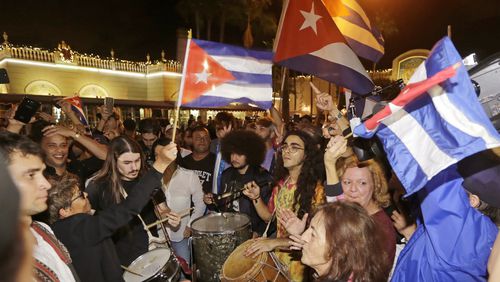 Cuban-Americans celebrate the death of Fidel Castro, Saturday, Nov. 26, 2016, in the Little Havana area in Miami. Castro died eight years after ill health forced him to formally hand power over to his younger brother Raul, who announced his death late Friday, Nov. 25, on state television. (AP Photo/Alan Diaz)