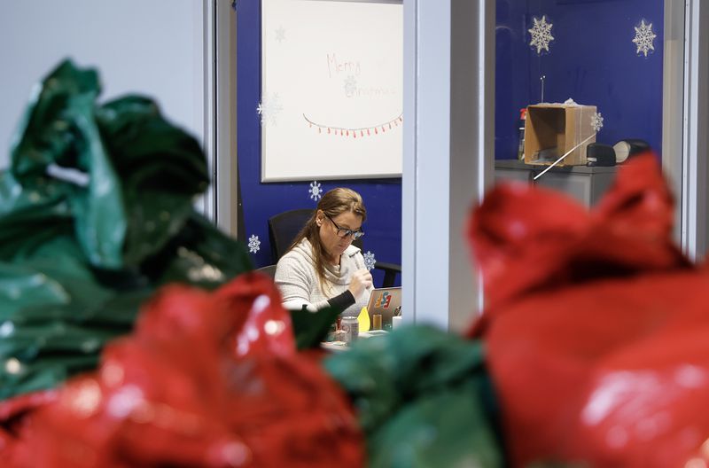 Empty Stocking Fund director Manda Hunt works in her office at the ESF warehouse in Atlanta on Wednesday, December 21, 2022. (Natrice Miller/natrice.miller@ajc.com)  