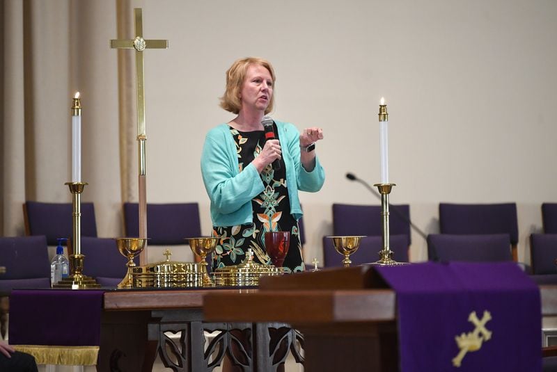 Bishop Sue Haupert-Johnson prepares the Communion table during an informational meeting Sunday at Kennesaw United Methodist Church. CONTRIBUTED BY JOHN AMIS