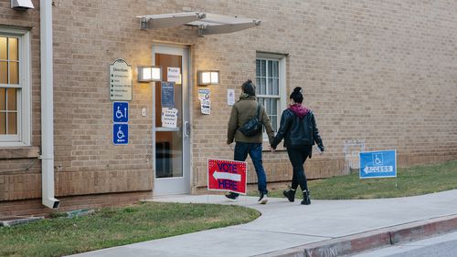 A couple holds hands as they walk into The Church at Ponce & Highland, a polling place in Atlanta last Tuesday. (Kendrick Brinson/The New York Times)