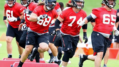 Atlanta Falcons offensive lineman Austin Pasztor (from left), Ty Sambrailo, and Brandon Fusco run an agility drill during team practice on Tuesday, June 5, 2018, in Flowery Branch.