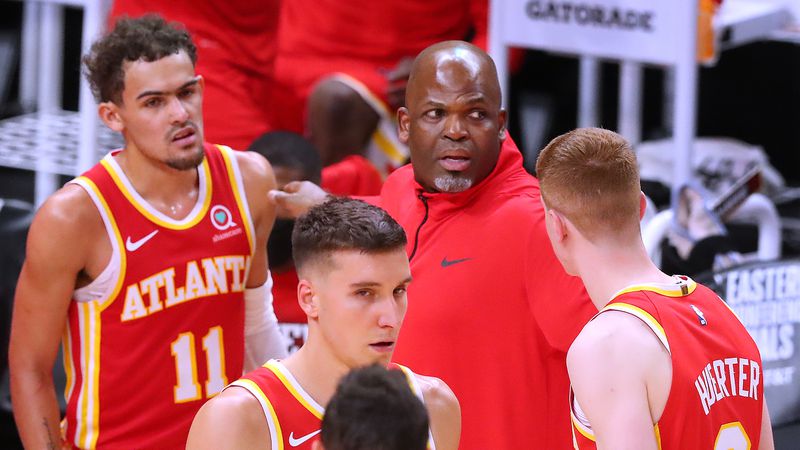 Hawks interim head coach Nate McMillan confers with Trae Young (from left), Bogdan Bogdanovic and Kevin Huerter during a time out in the final minutes of 113-102 loss to the Milwaukee Bucks in Game 3 of the Eastern Conference finals Sunday, June 27, 2021, at State Farm Arena in Atlanta. (Curtis Compton / Curtis.Compton@ajc.com)