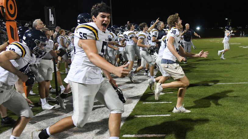 Time to celebrate: The Marist sideline celebrates after Friday's 28-13 victory over Blessed Trinity.