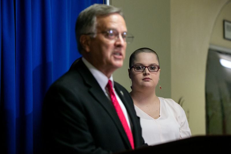 Hailie Massey, right, watches as Rep. Jeff Jones, R-Brunswick, announces a proposed bill called Hailie’s Amendment at a press conference at the Georgia Capitol. Under the bill, the legislative leave law would no longer cover cases involving alleged sexual or violent crimes. REBECCA WRIGHT / FOR THE AJC
