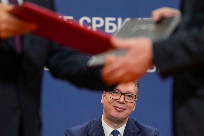 Serbian President Aleksandar Vucic looks on as documents are exchanged after the signing of an agreement during visit of Chinese President Xi Jinping at the Serbia Palace, in Belgrade, Serbia, Wednesday, May 8, 2024. (AP Photo/Darko Vojinovic)