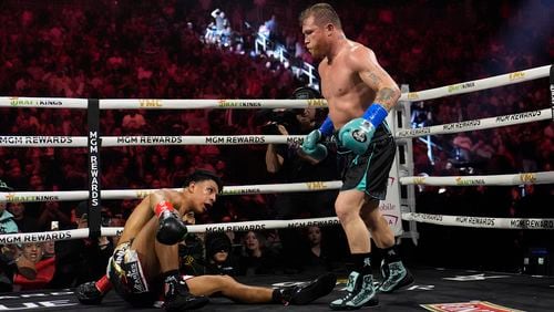 Canelo Alvarez knocks down Jaime Munguia in a super middleweight title fight Saturday, May 4, 2024, in Las Vegas. (AP Photo/John Locher)