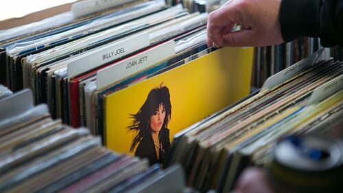 A customer flips through Joan Jett albums at Mojo Vinyl Records in Roswell. STAFF / 2015 photo
