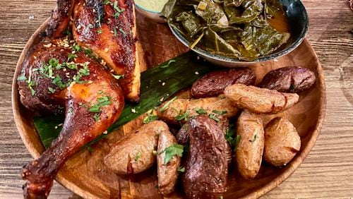 Pollo a la brasa is served with collard greens and fingerling potatoes at Tio Lucho’s. Angela Hansberger for The Atlanta Journal-Constitution
